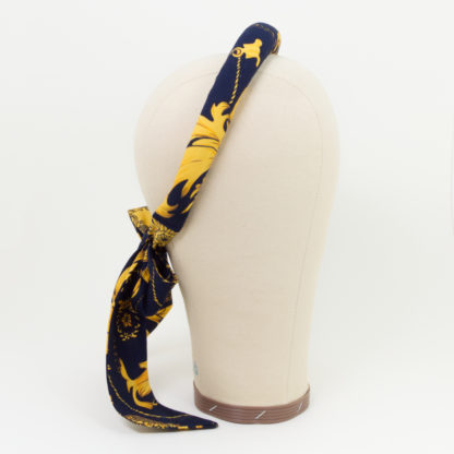 Padded headband with bow in elegant retro pattern side view
